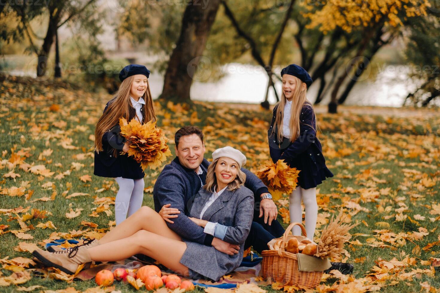 A big family on a picnic in the fall in a nature park. Happy people in the autumn park photo
