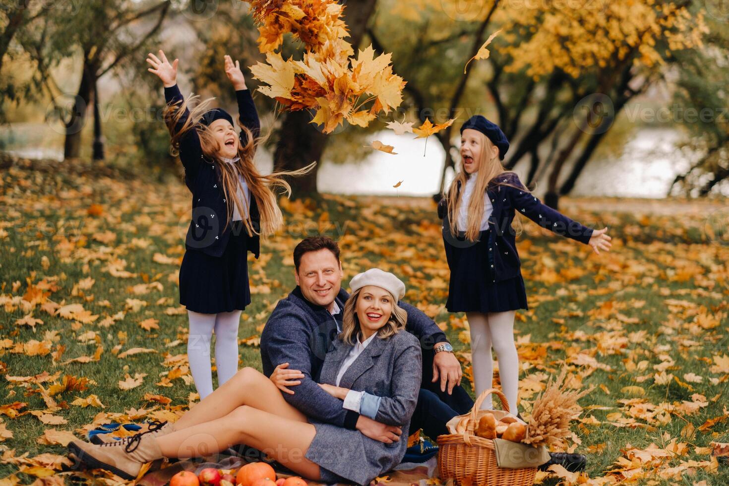 A big family on a picnic in the fall in a nature park. Happy people in the autumn park photo