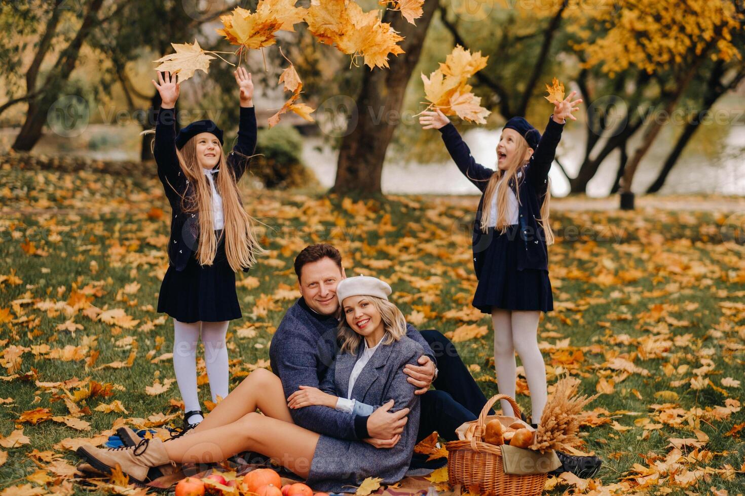 A big family on a picnic in the fall in a nature park. Happy people in the autumn park photo