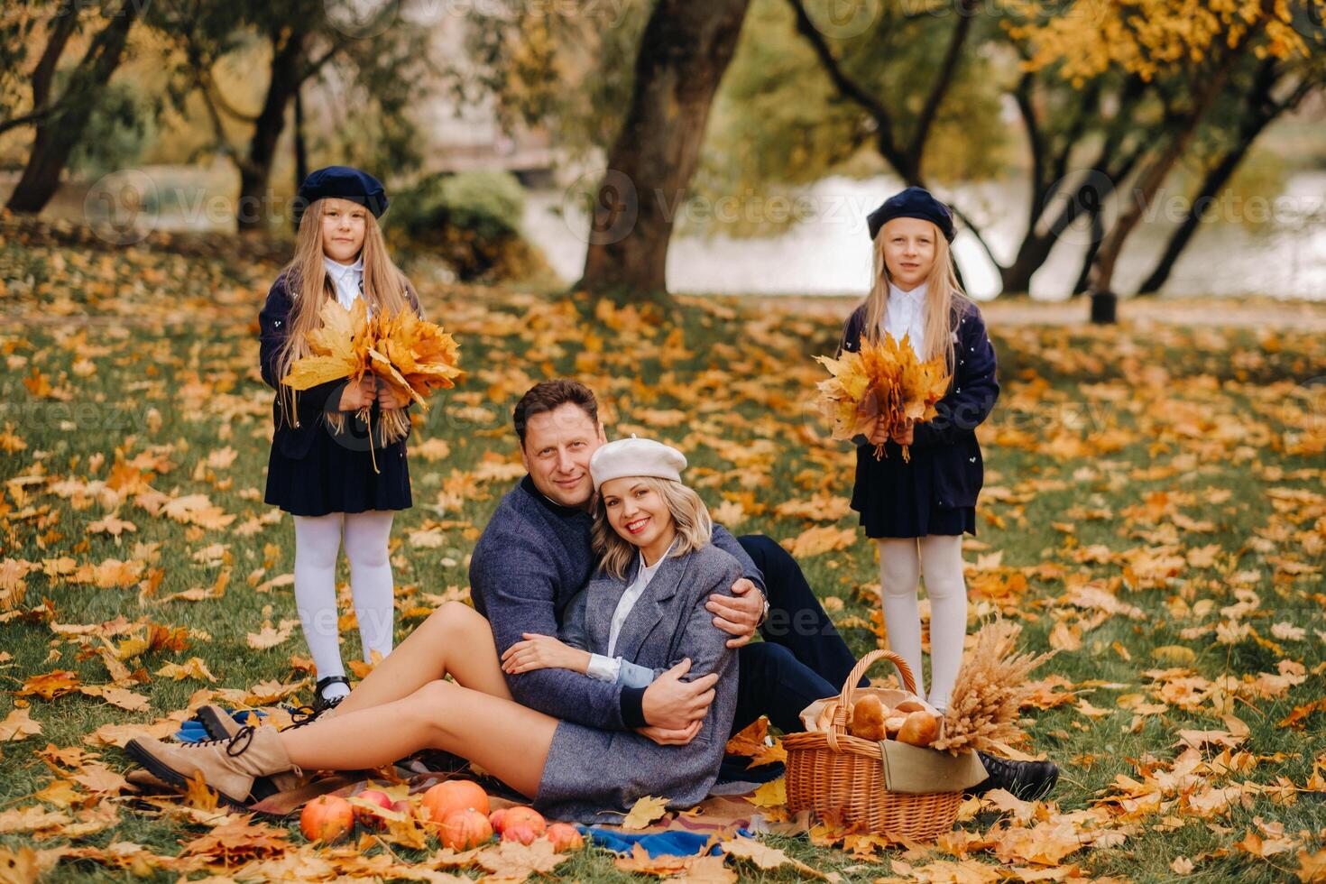 A big family on a picnic in the fall in a nature park. Happy people in the autumn park photo