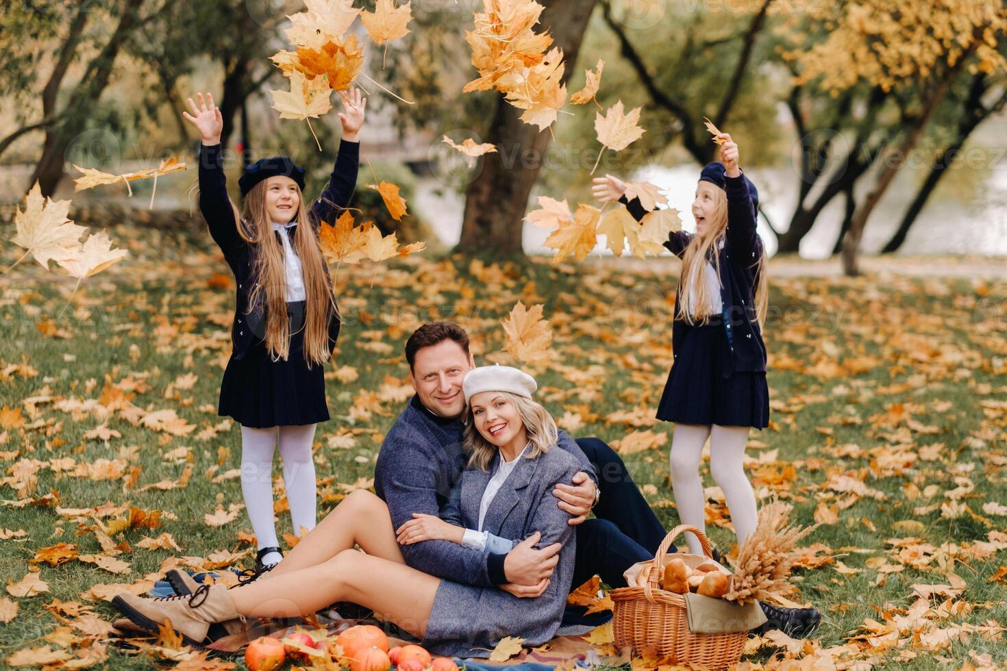 A big family on a picnic in the fall in a nature park. Happy people in the autumn park photo