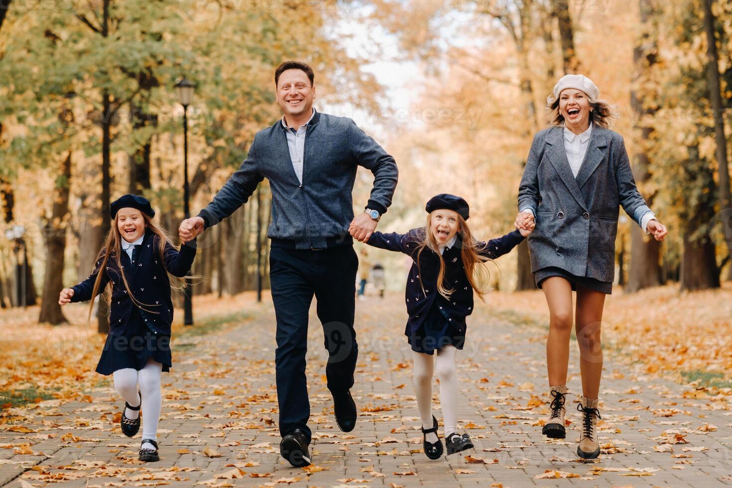 A large family walks in the park in the fall. Happy people in the autumn park photo