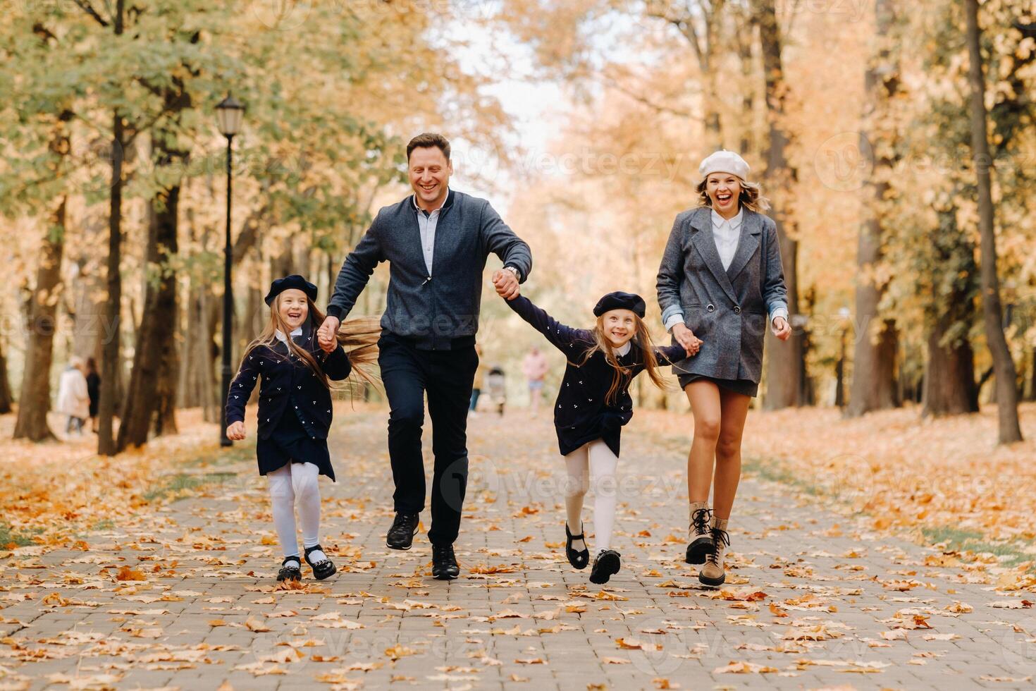 A large family walks in the park in the fall. Happy people in the autumn park photo