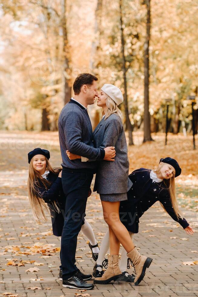 A large family walks in the park in the fall. Happy people in the autumn park photo