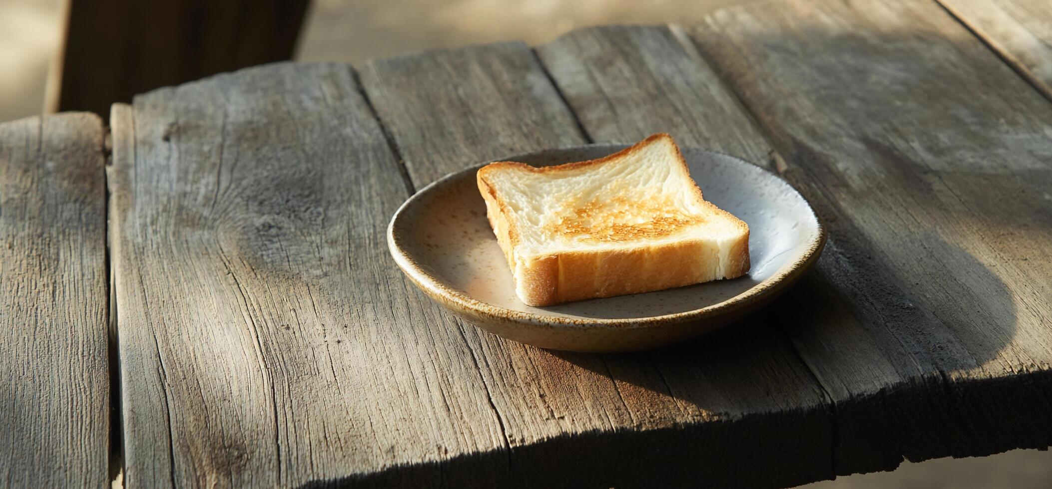 A piece of bread on a plate on a table photo