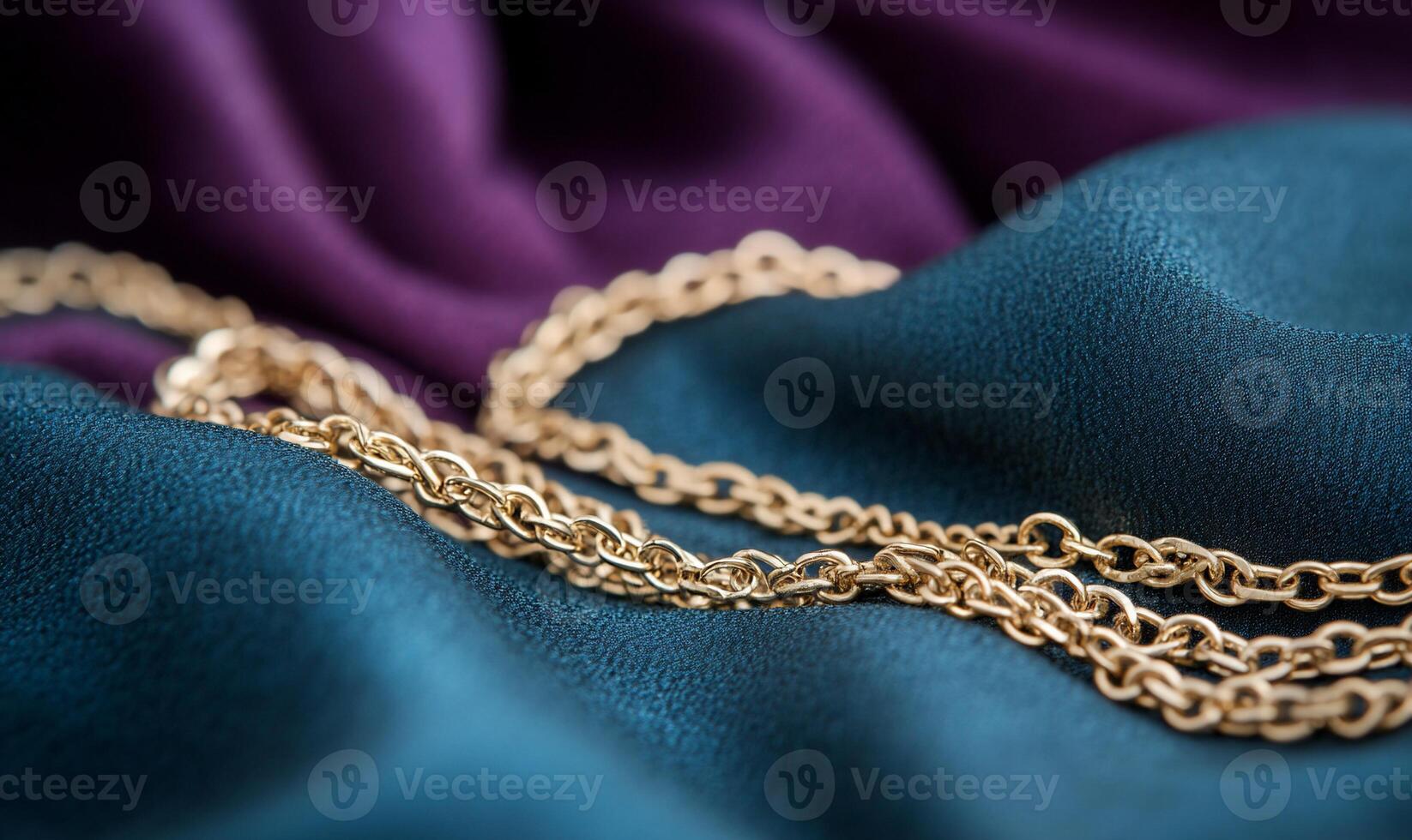 Gold chain on purple cloth photo