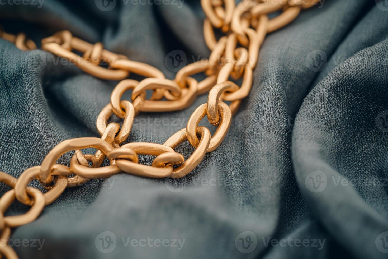 Gold chain on a blue cloth photo