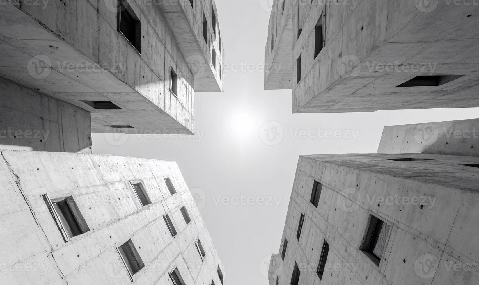 A black and white photo of a building with a sun in the sky