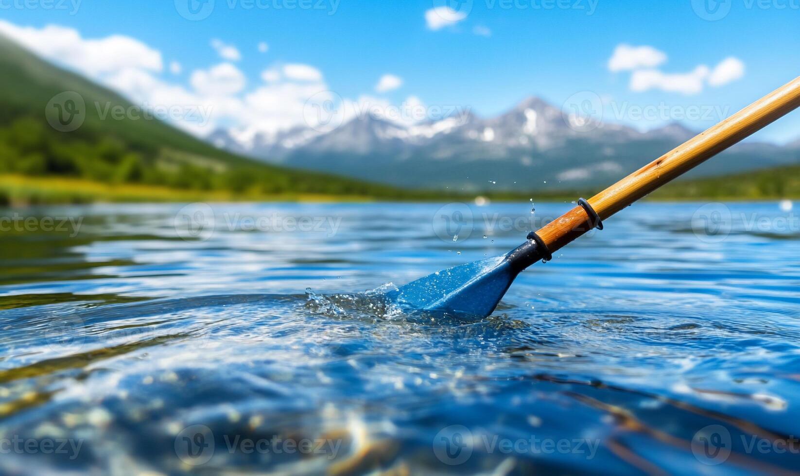 A paddle is in the water with mountains in the background photo