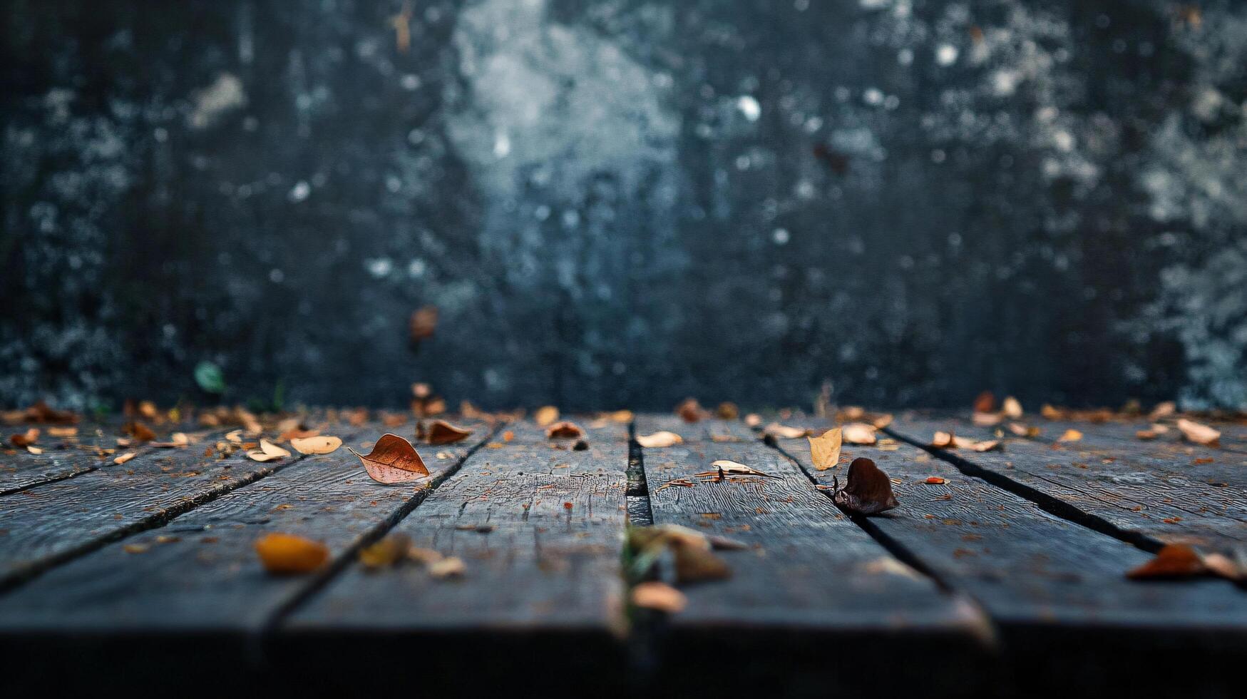 Wooden table with leaves scattered across it. Scene is calm and peaceful, as the leaves are gently falling and creating a serene atmosphere photo