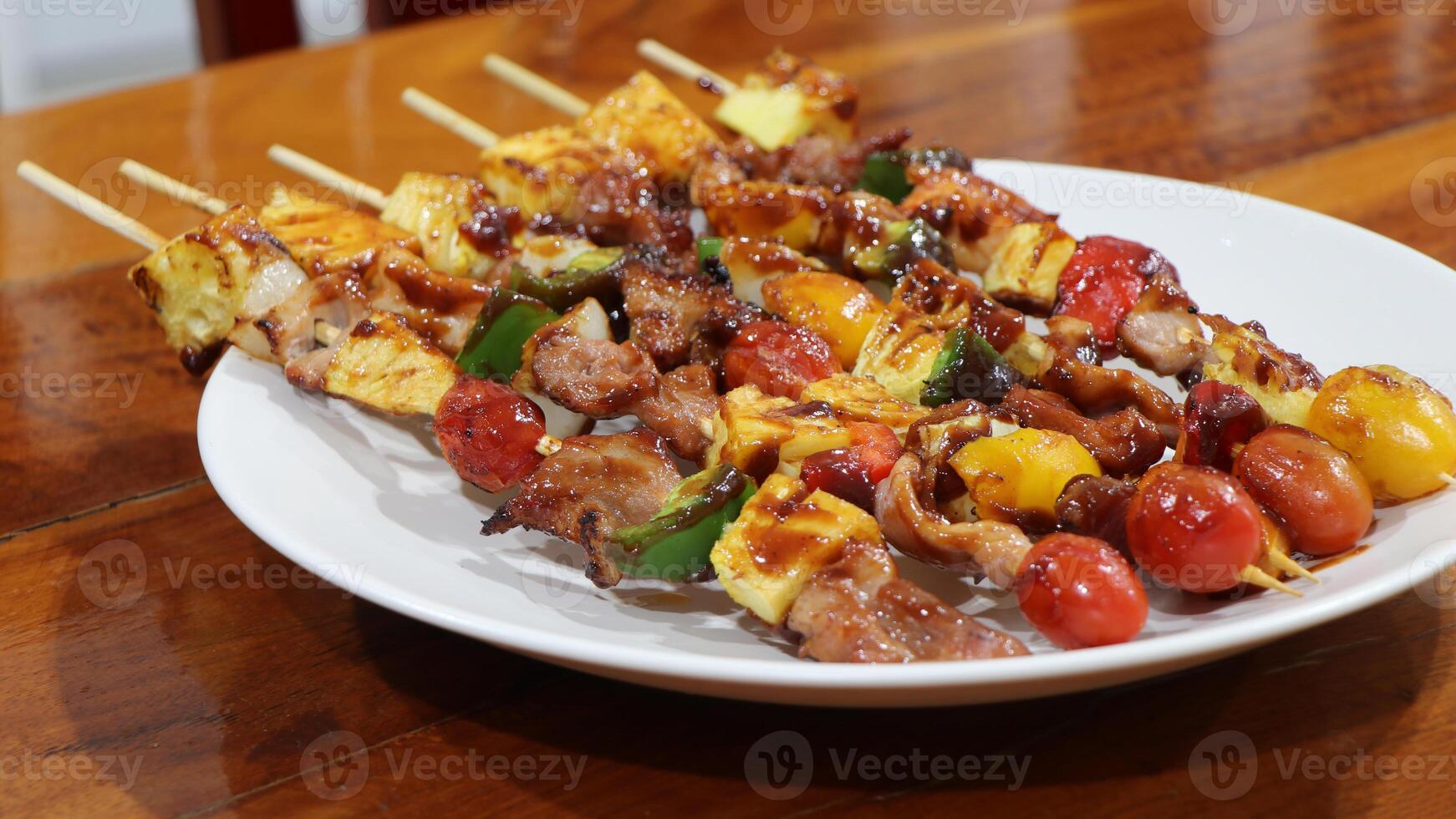 Close up BBQ grills at barbecue party on white dish at countryside in holiday. Grilled vegetables and chicken meat skewers grilled on table, appetizing. photo