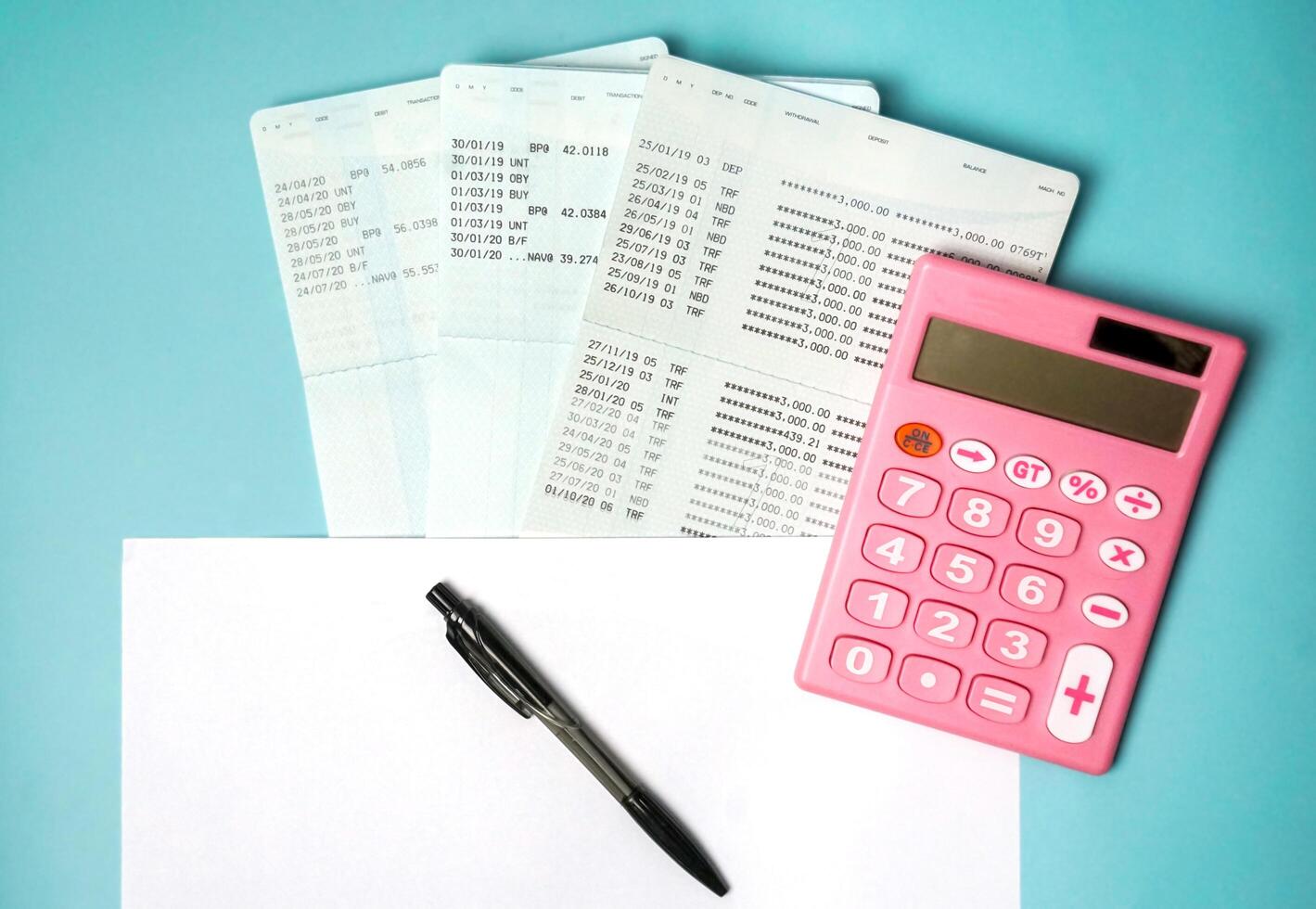 Top view of pink calculators, pen, savings documents, and investing concepts from a financial planner. photo