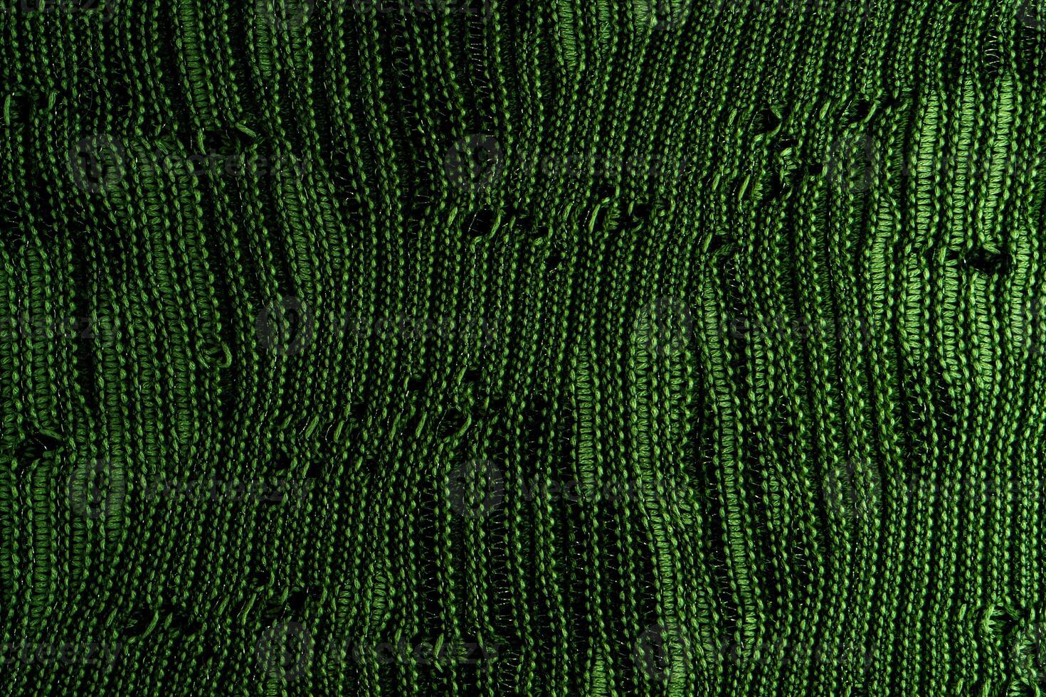 A close-up of green knitted fabric texture, detailed pattern, and vibrant color, suitable for backgrounds. photo