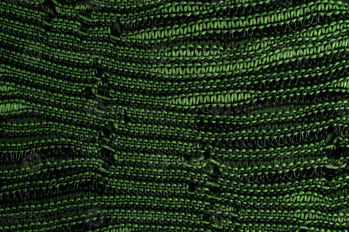 A close-up of green knitted fabric texture, detailed pattern, and vibrant color, suitable for backgrounds. photo