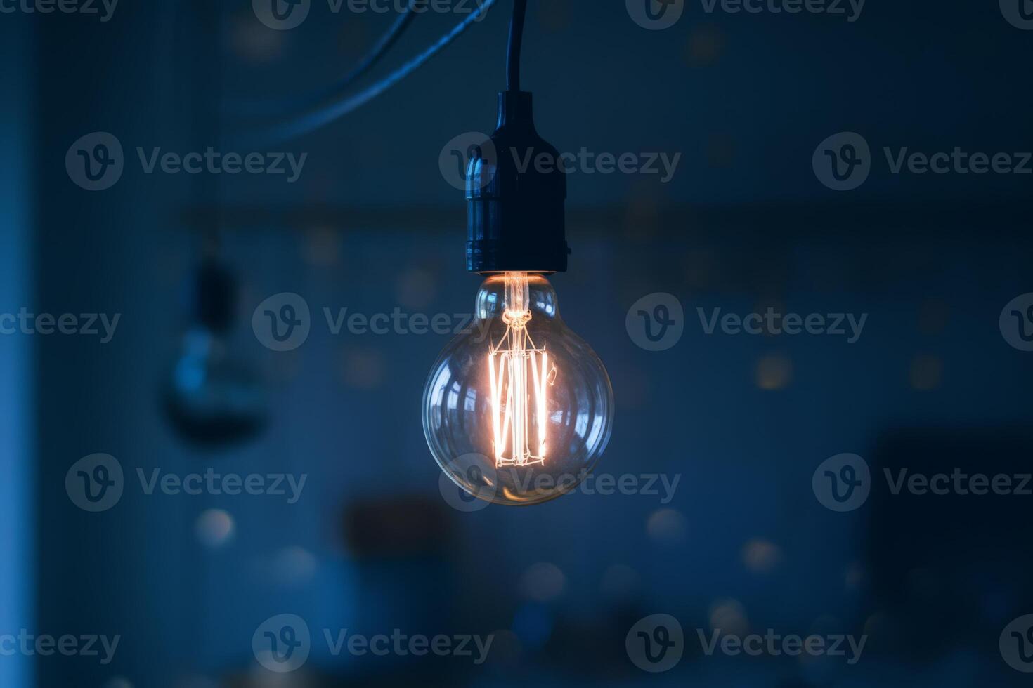A light bulb is shown in a dark room photo