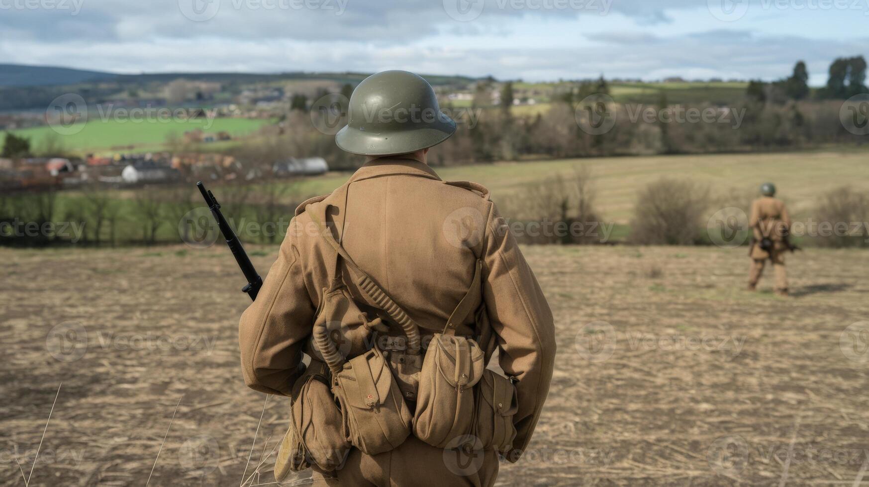 A soldier in a field with a rifle photo