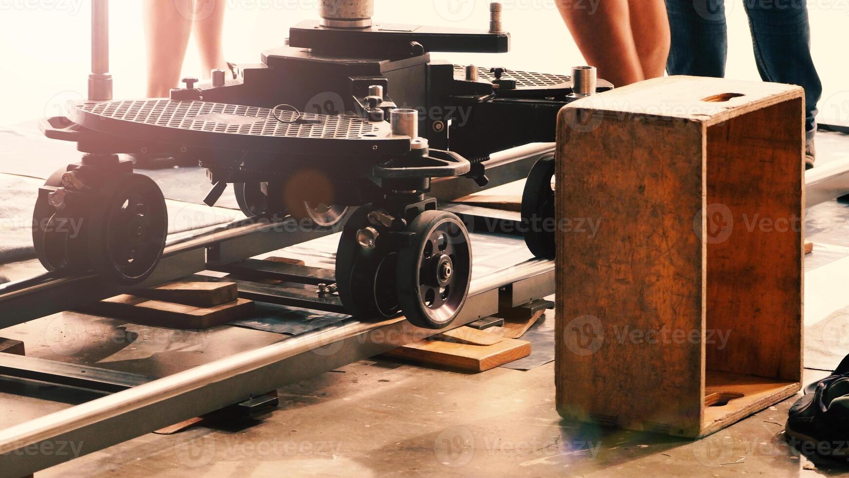 Camera trolley or camera dolly cart rails for filmmaking on studio shooting set. Pro videographer dolly rail track for filming movie mounted on studio floor. Film production dolly and crews in set. photo