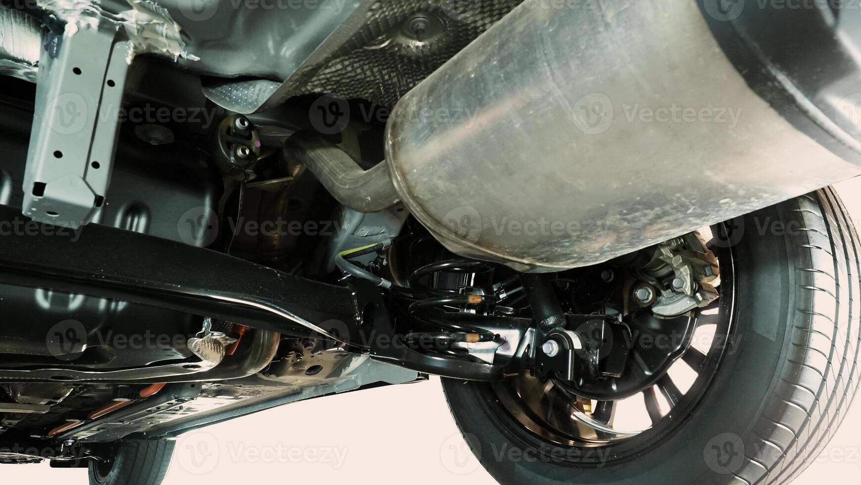 Under car exhaust pipe and suspension. Automotive mufflers. Inspection of car for Defects. Metal fittings and pipes for the muffler. Suspension elements and exhaust system. Auto parts and car service photo