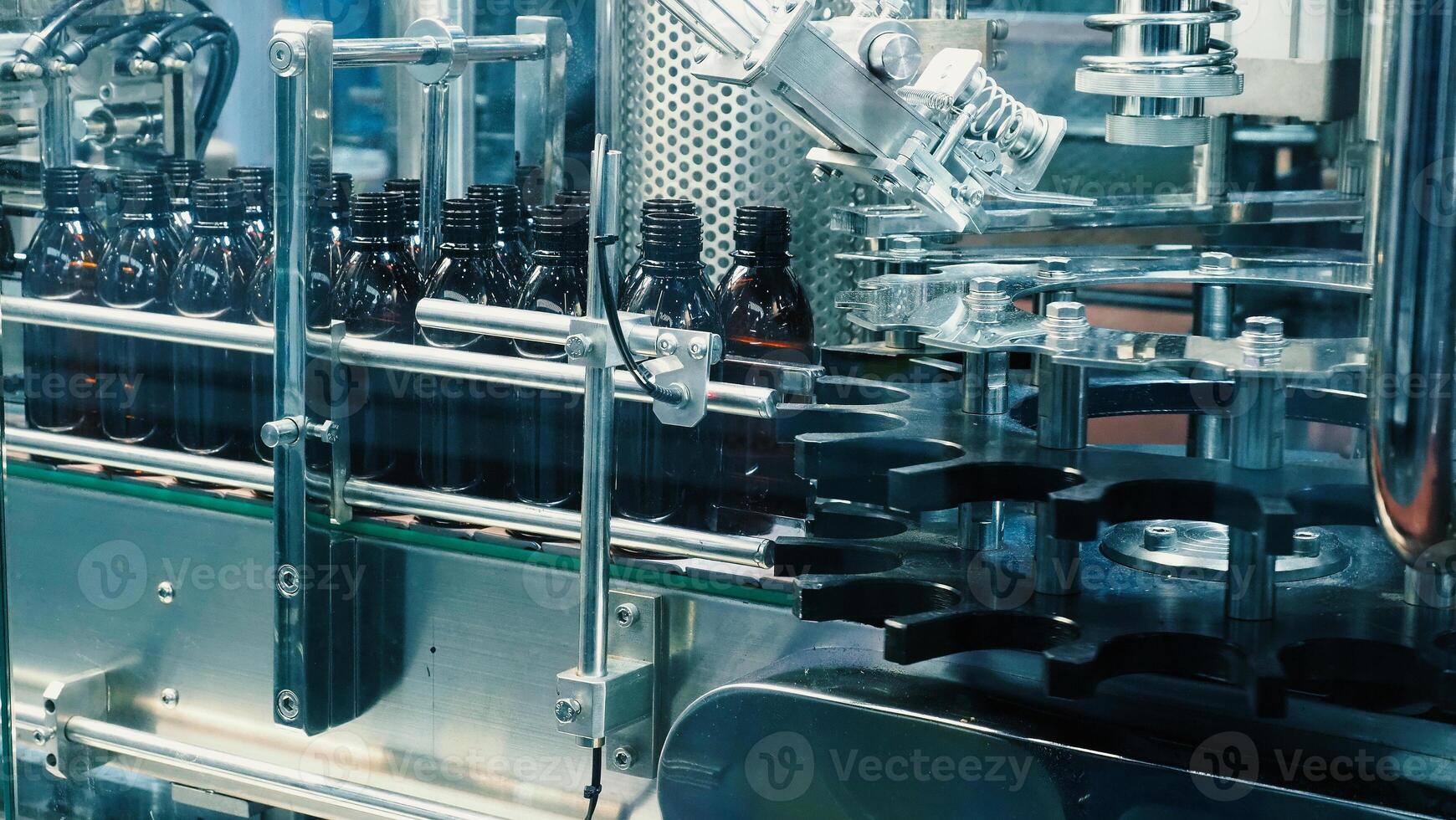 Technology demonstration of filling and capping bottles in the industry. photo