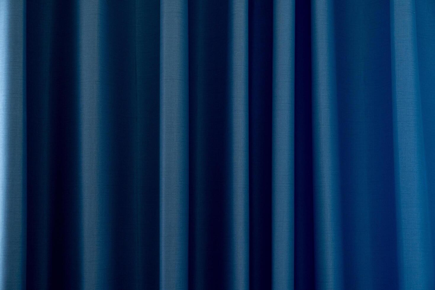 The blue curtains curved as the curtains moved. Curtains to block the view from outside. photo