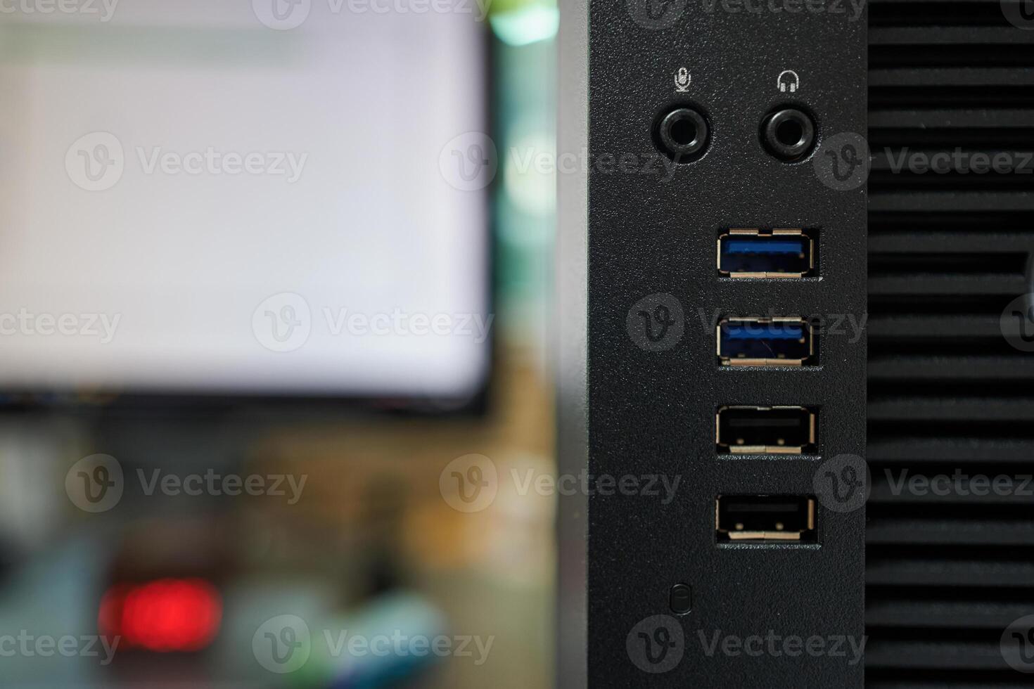 close up of a computer usb port with monitor in background photo