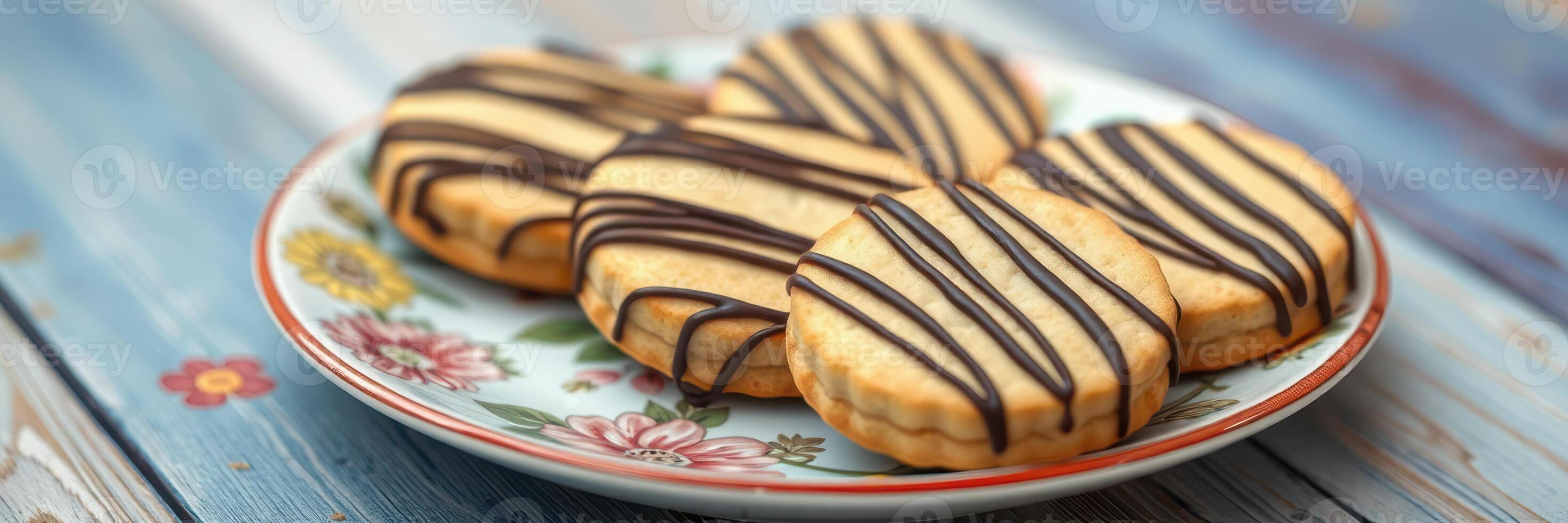 Delicious homemade cookies arranged on a floral plate with chocolate drizzle photo