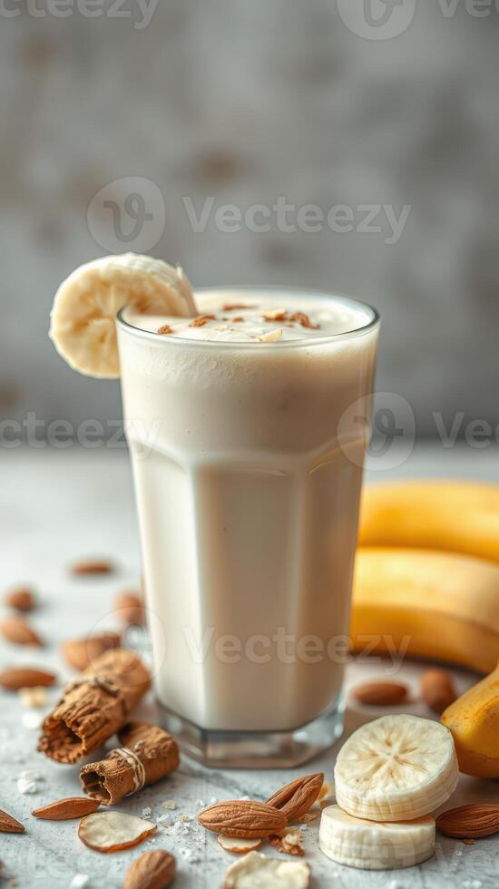 Creamy banana smoothie with almonds captures refreshing taste in a cozy kitchen setting photo