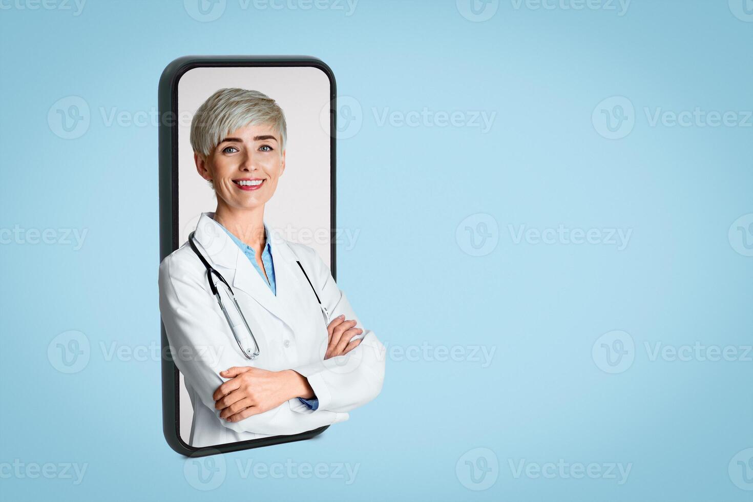 Professional concept. Portrait of smiling young woman doctor in white coat with stethoscope, isolated over light background photo
