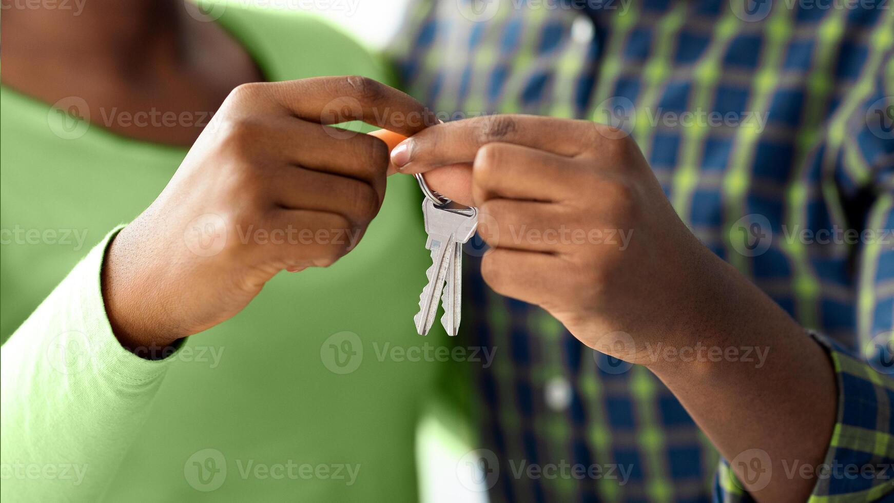 New Home Concept. Closeup Shot Of Happy Black Couple Holding Keys Together, African American Spouses Enjoying Moving To Their Own House, Celebrating Relocation And Buying New Flat, Cropped photo
