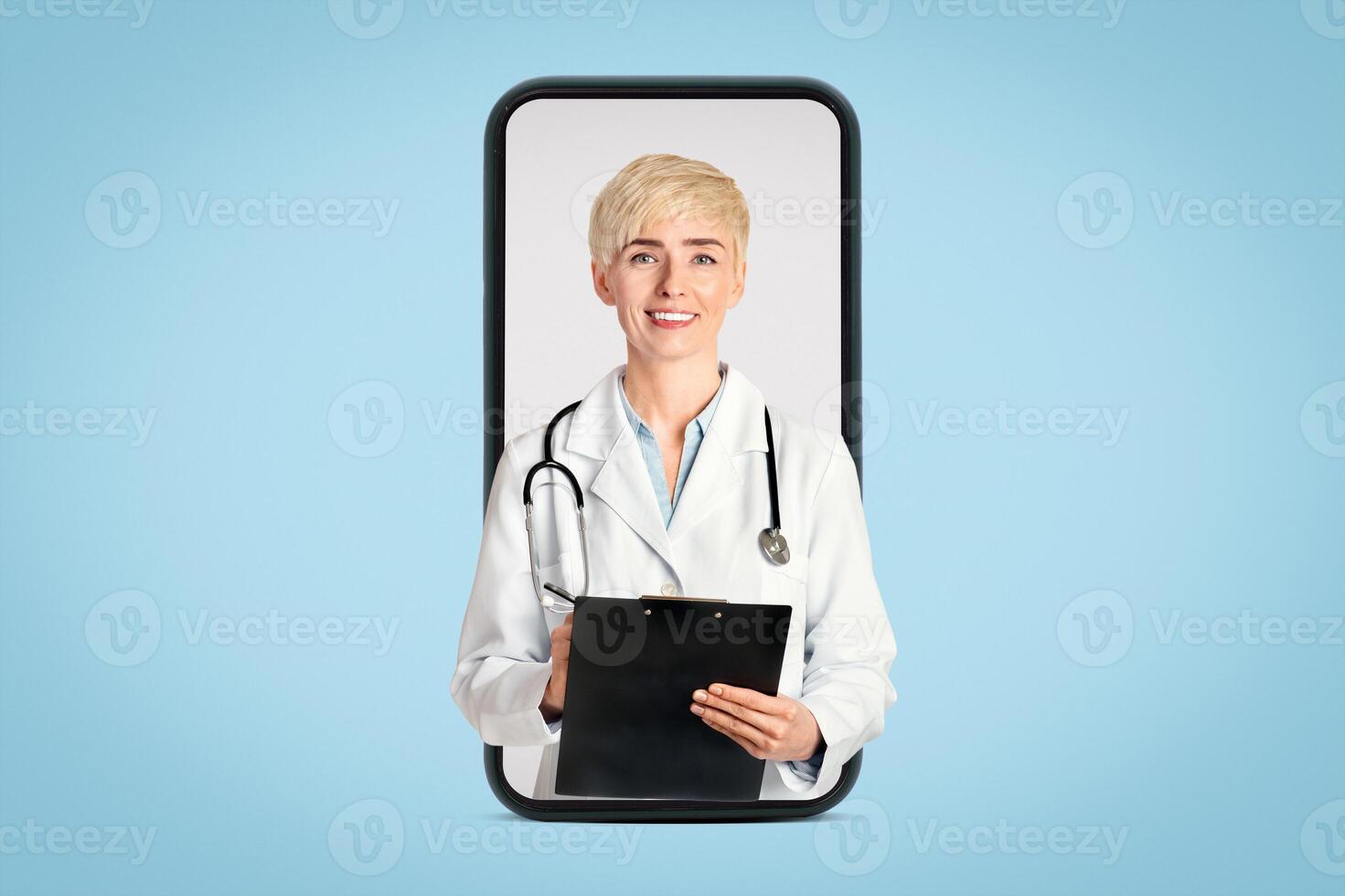 Medical professions, healthcare and prevention. Smiling adult woman in white coat with stethoscope taking notes in tablet and looking at camera isolated on gray background, cut out, free space photo