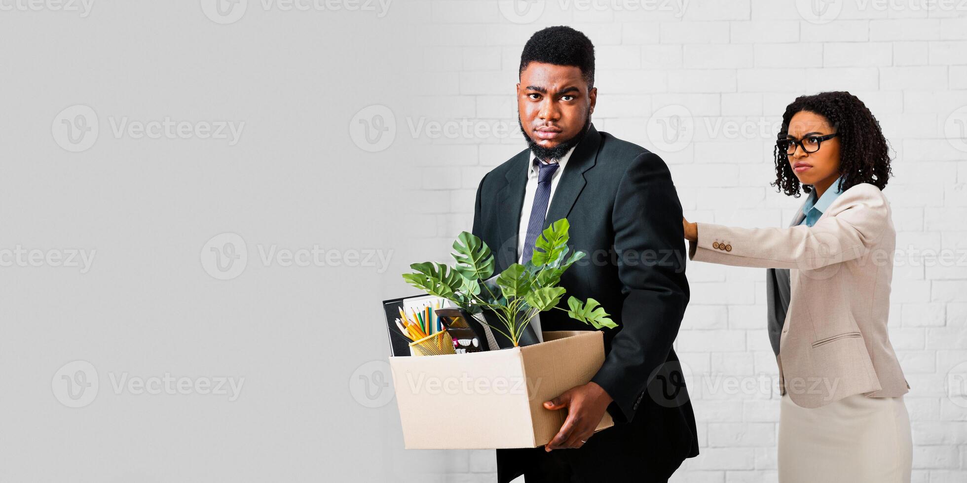 Crisis and unemployment concept. African American businesswoman firing upset male employee at office photo