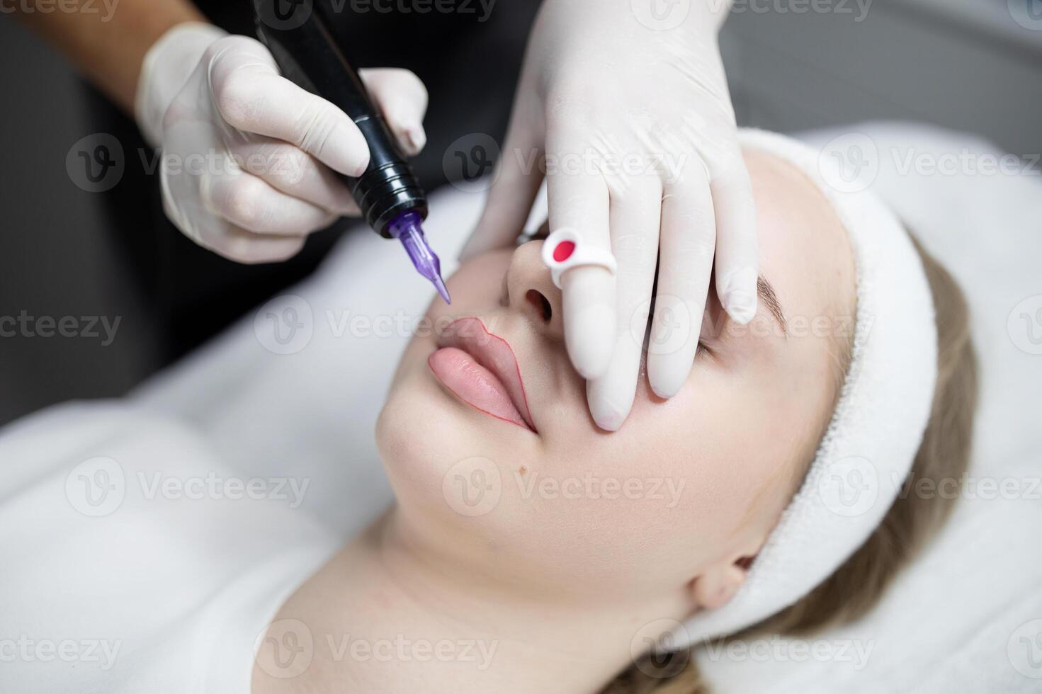 Ladies relax in a beauty salon while receiving a permanent makeup procedure. The session focuses on enhancing their features for a long-lasting look, celebrating self-care and beauty. photo