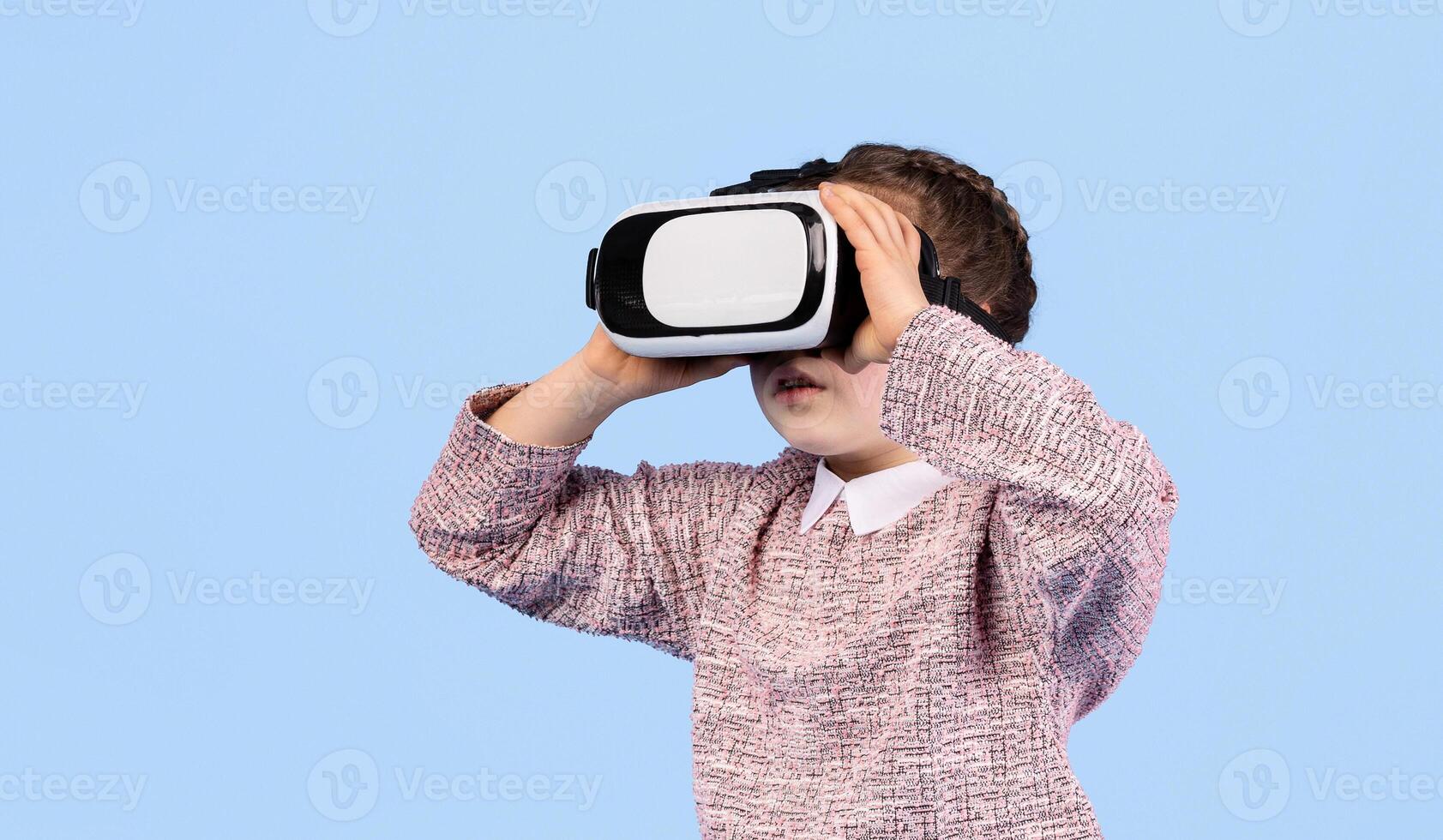 A happy girl engages with virtual reality technology, exploring a captivating digital world. photo