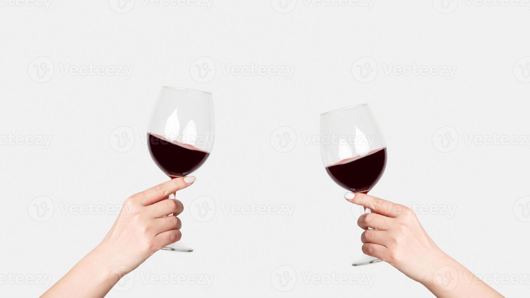 Young girl holding glass of tasty red wine on white background, close up photo