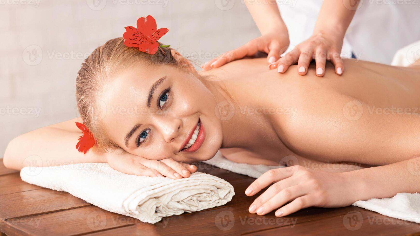 Millennial woman have hot stone massage in spa salon photo