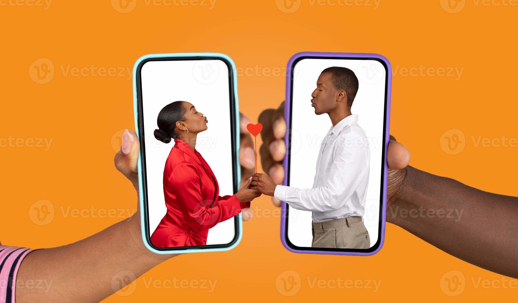 A couple holds their smartphones, sharing a heartfelt moment as they communicate through a messaging app. Their hands touch a heart symbol, showcasing love and connection. photo