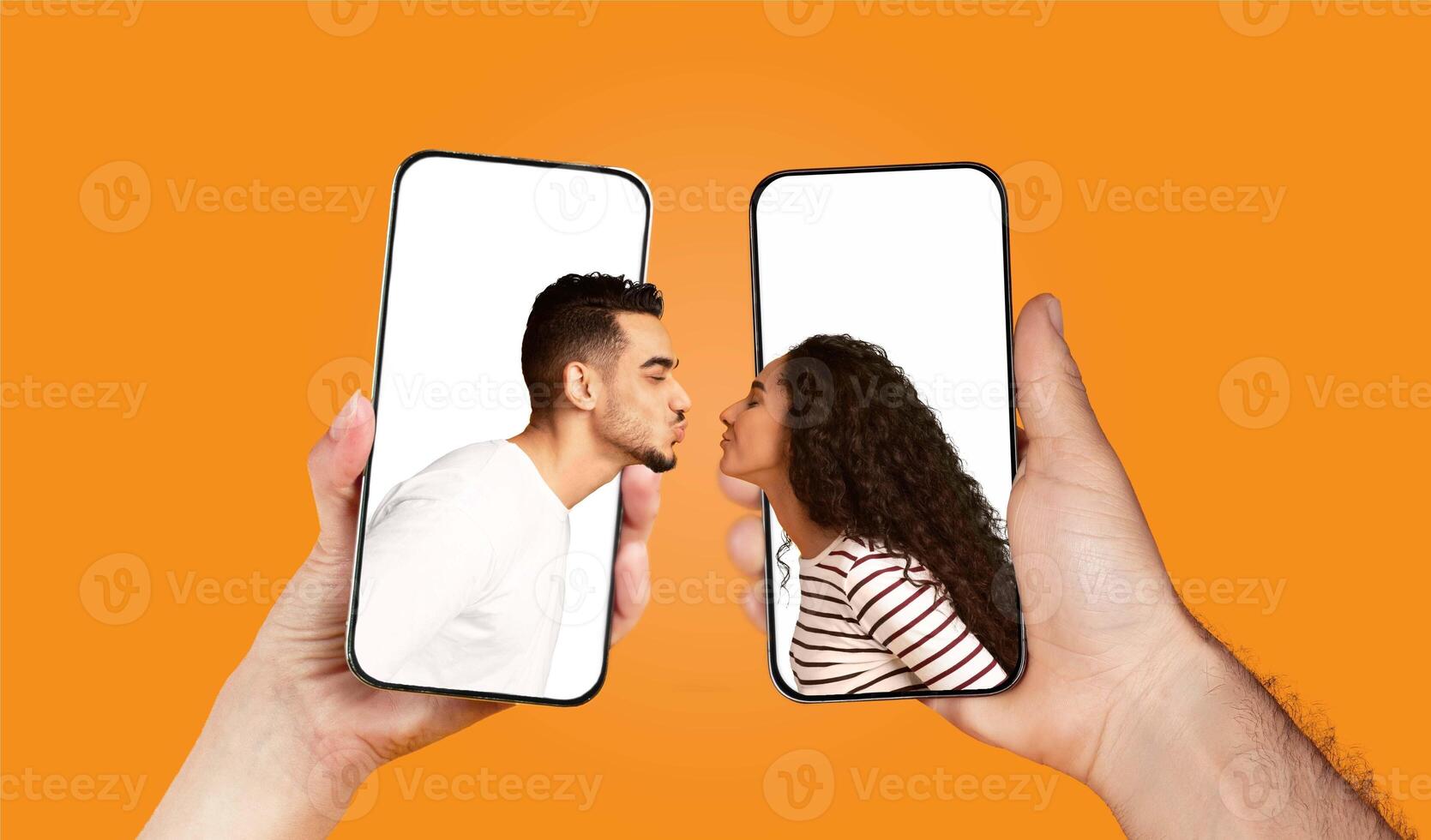 A couple playfully engages in a chat using their smartphones, sharing love and affection. Their hands hold the devices as they lean in for a kiss, embodying connection and romance. photo