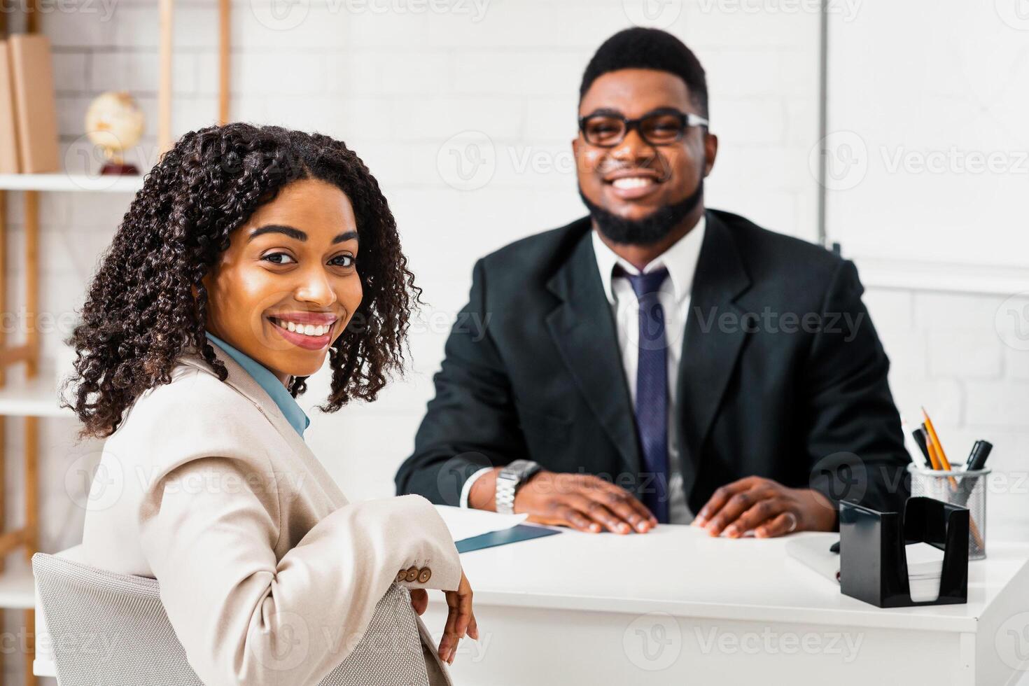 Smiling personnel manager and African American vacancy candidate on job interview in office. Panorama photo