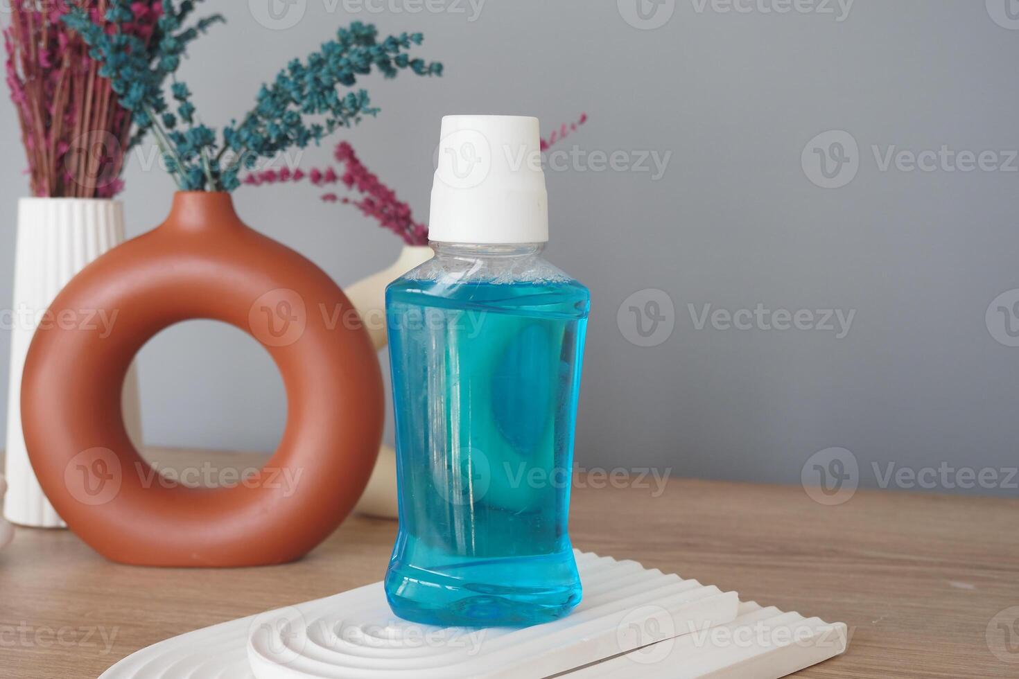 mouthwash liquid in a container on table photo