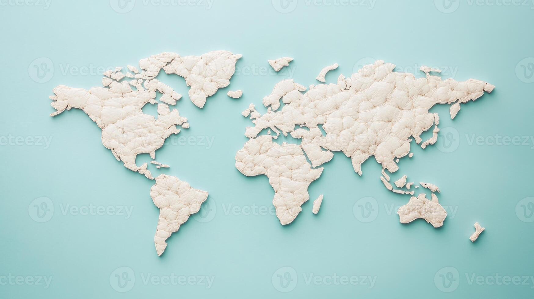 A tactile world map crafted from cotton sits against a calming blue backdrop, symbolizing global connections photo
