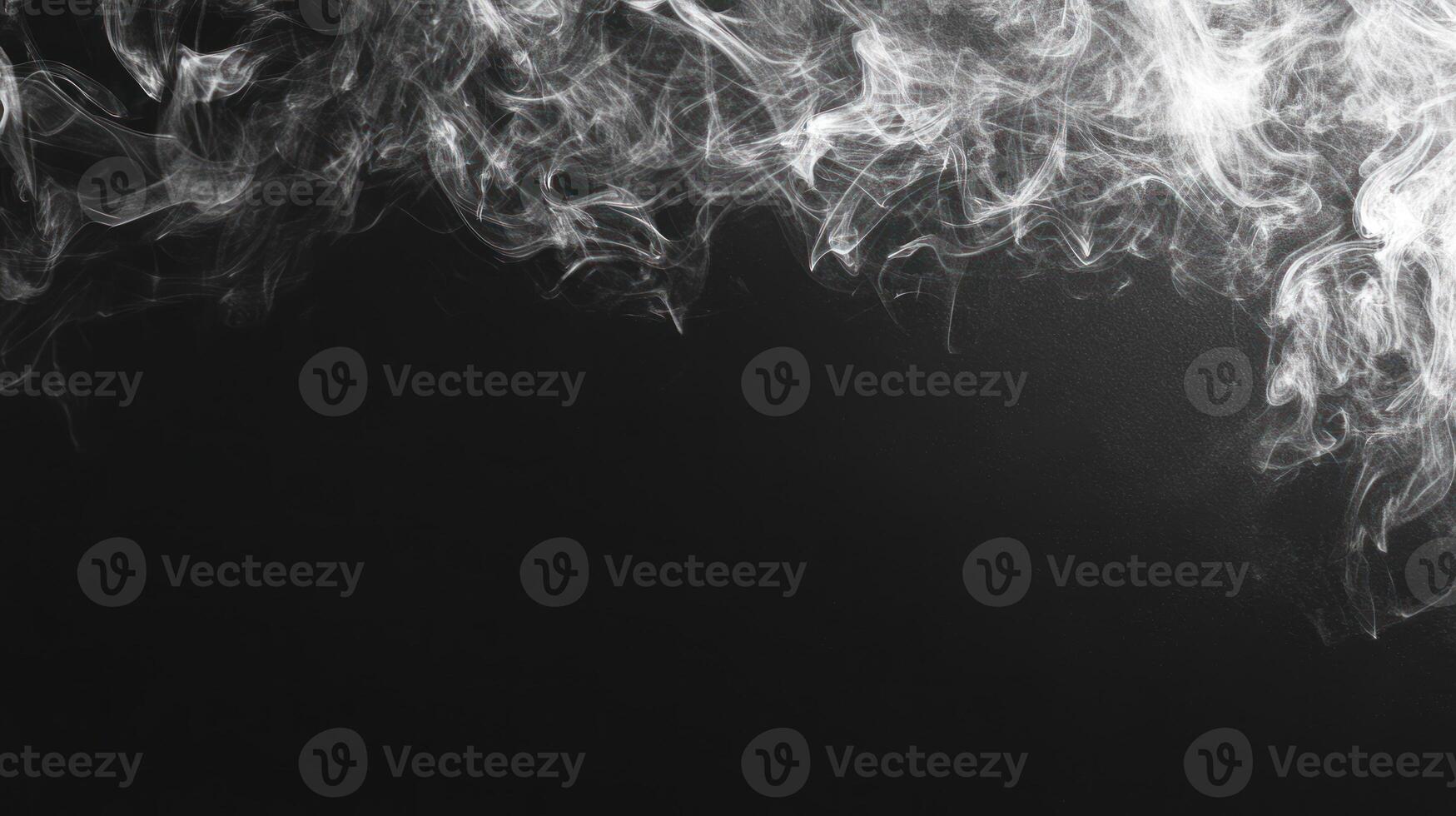 Swirling patterns of smoke gracefully ascend into the air, creating an ethereal effect against a dark backdrop photo