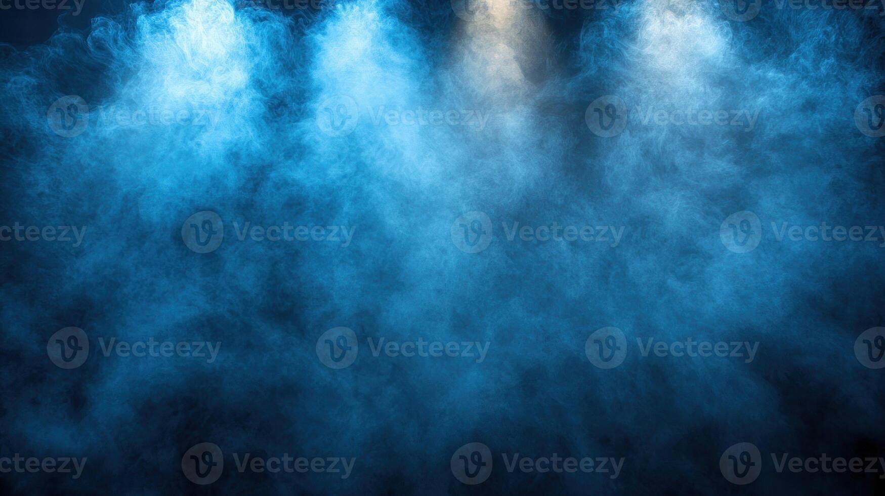 A blue fog fills the air under focused lights, setting a mysterious and moody atmosphere for any event or performance photo