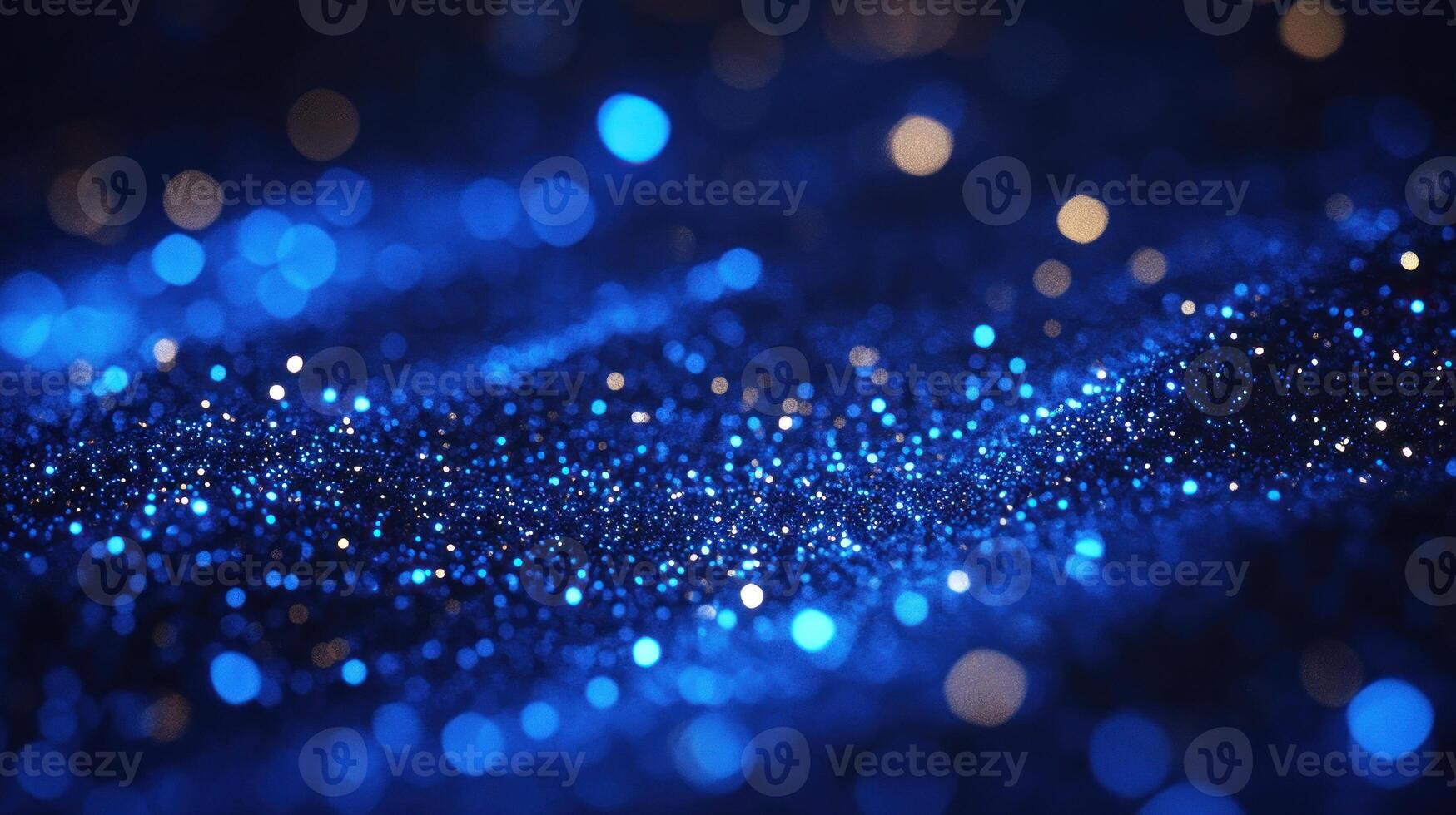 Glitter sparkles in shades of blue and gold across a dark surface, evoking a magical, starry night effect photo