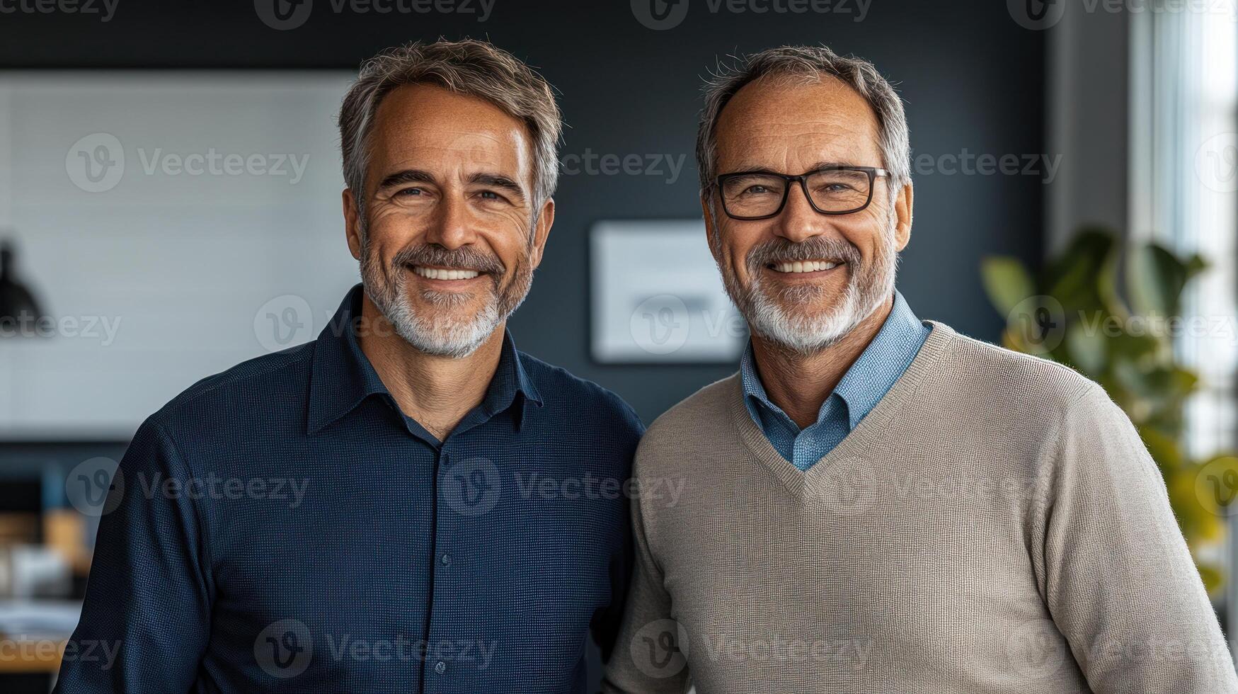 Two friendly men pose for a picture in a contemporary office environment filled with natural light photo
