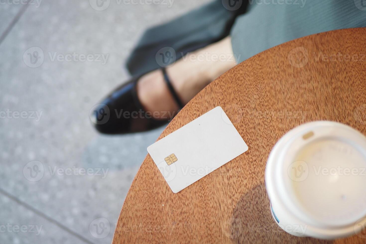 Enjoying a Coffee Break with a Credit Card placed on the Table photo