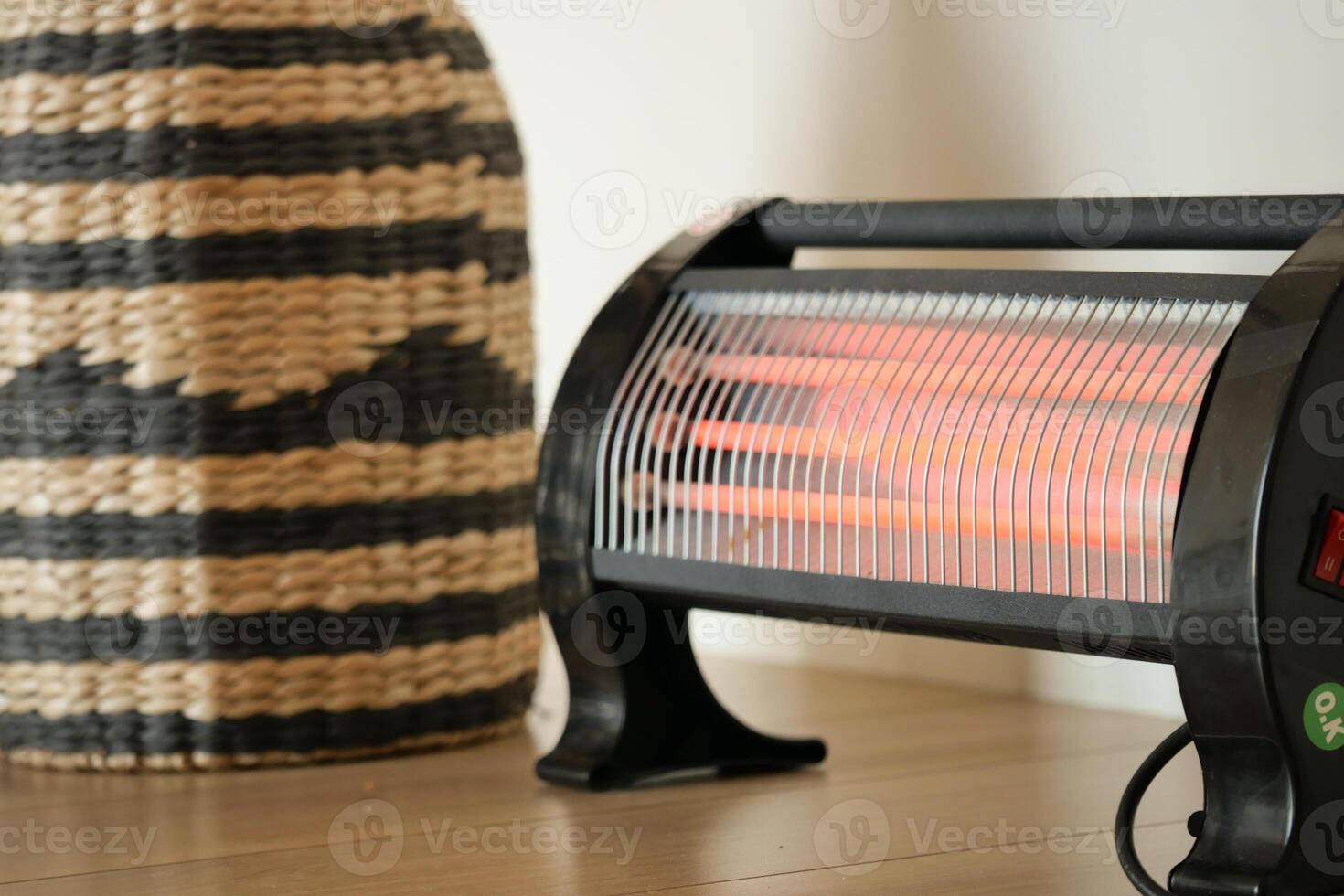 Modern electric infrared heater in living room, closeup photo