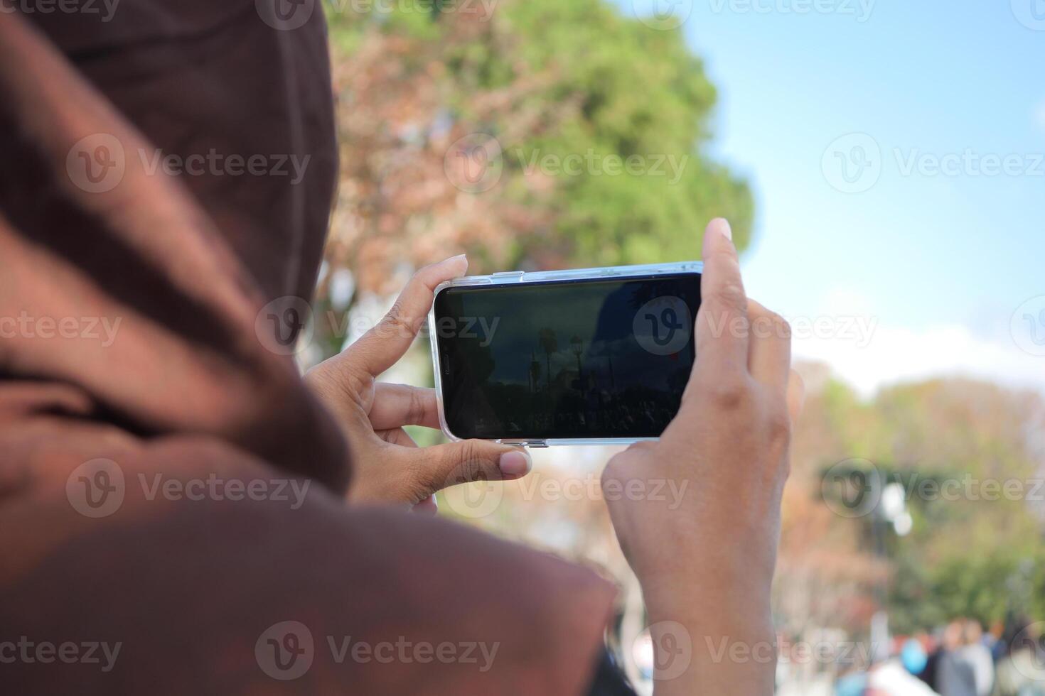Capturing Moments. A Person Taking Photos Outdoors with Smartphone