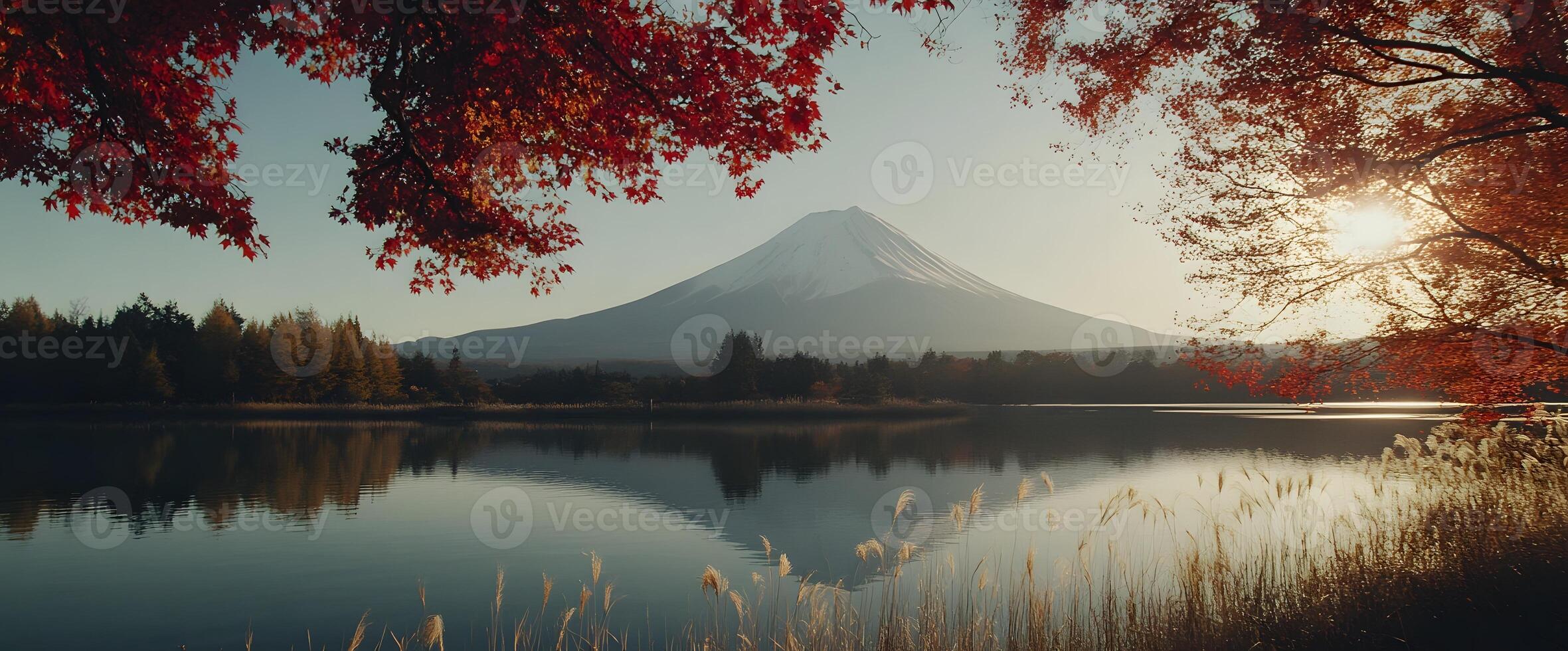 Majestic Mount Fuji Reflected in Calm Lake Water, Framed by Red Autumn Leaves photo