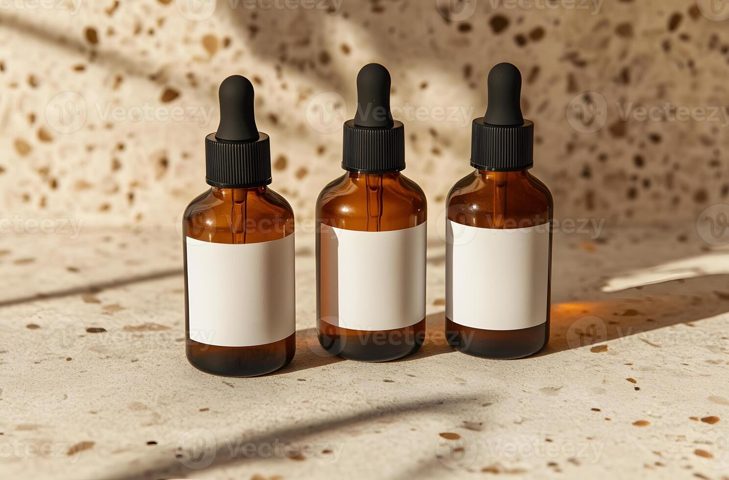 Three Amber Glass Dropper Bottles with White Labels on a Light Beige Surface photo