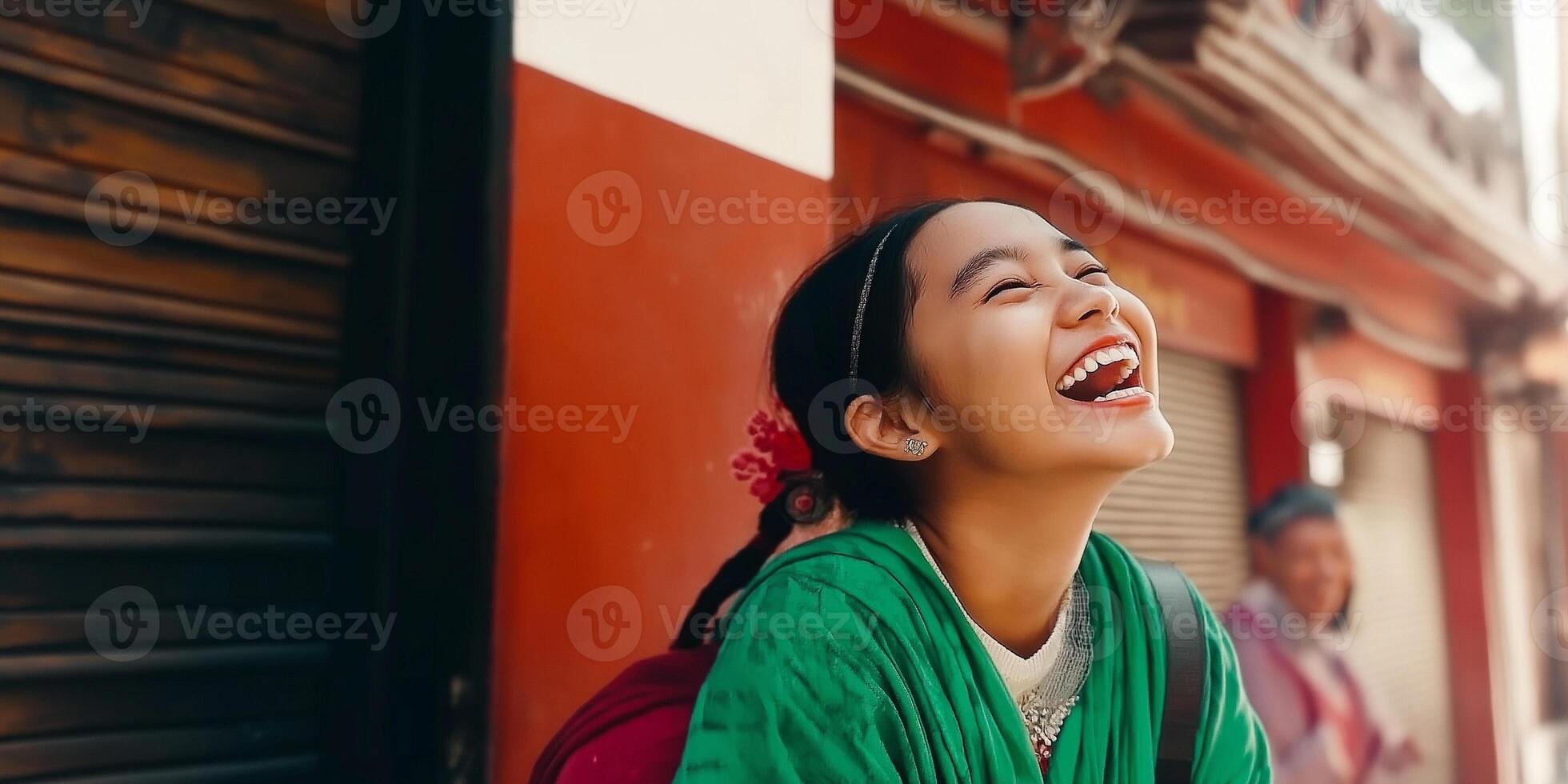 A woman laughing in a city street photo